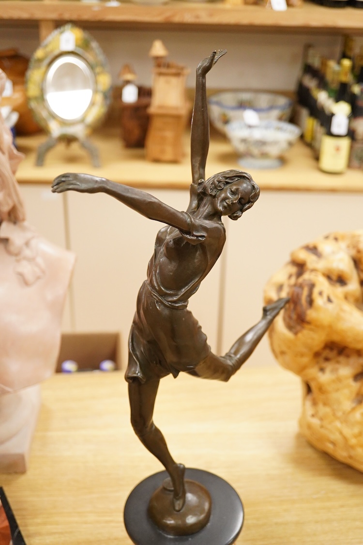After Bruno Zach (1891-1945), an Deco style bronze of a dancing lady, raised on a marble and slate base, 65cm high